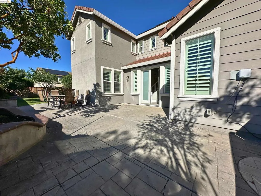 Expansive stamped concrete patio with direct access to interior spaces through a sliding glass door