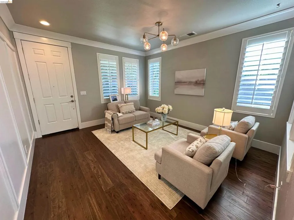 Warm-toned wood-finish flooring complements the neutral wall palette