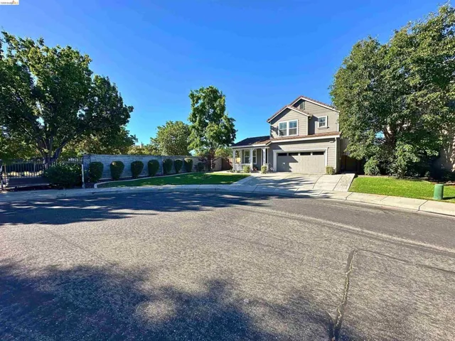Two-story home with a two-car garage, front porch, and concrete driveway