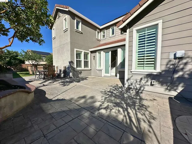 Expansive stamped concrete patio with direct access to interior spaces through a sliding glass door