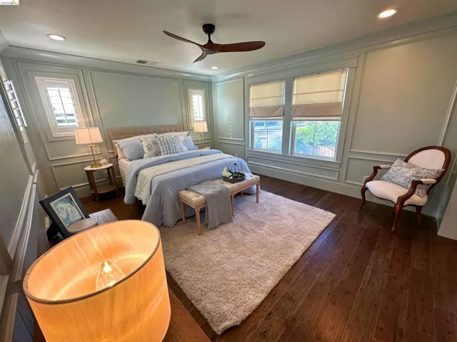 Expansive room featuring wood-finish flooring, recessed lighting, and a ceiling fan