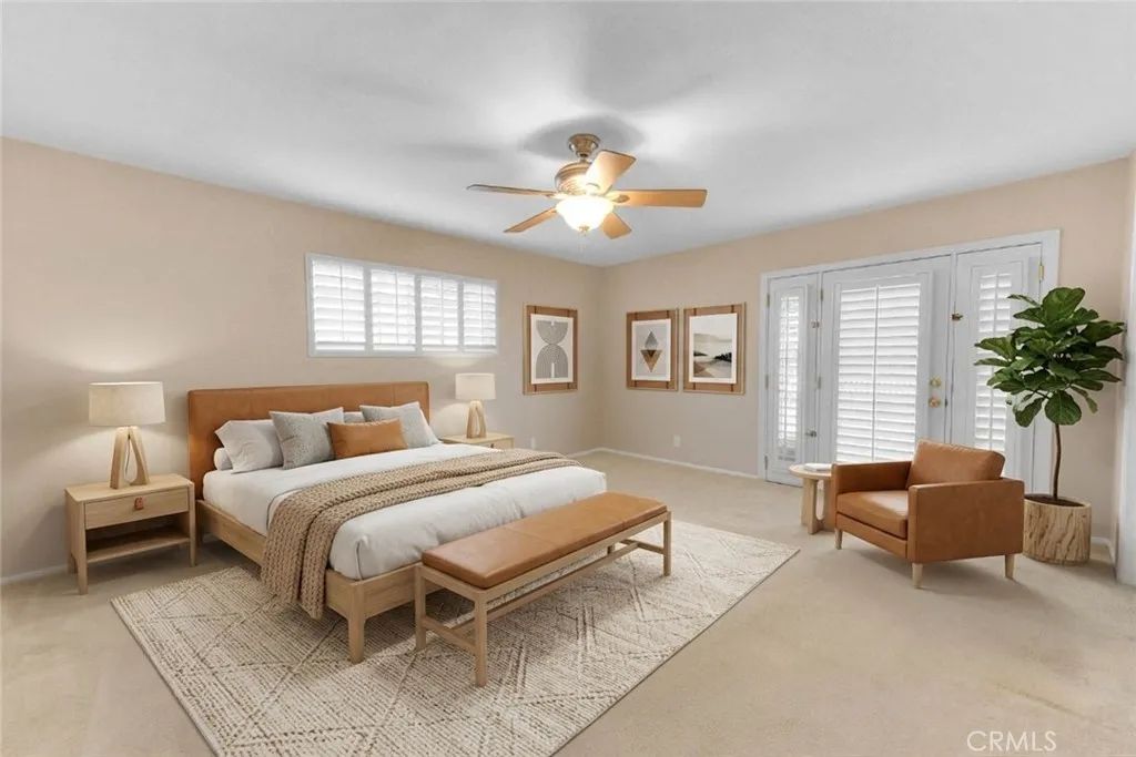 Very Spacious Primary Bedroom.  Entry Door Leads To Rear Yard.  Plush Carpeting.  Overhead Fan For Cooling Breeze.