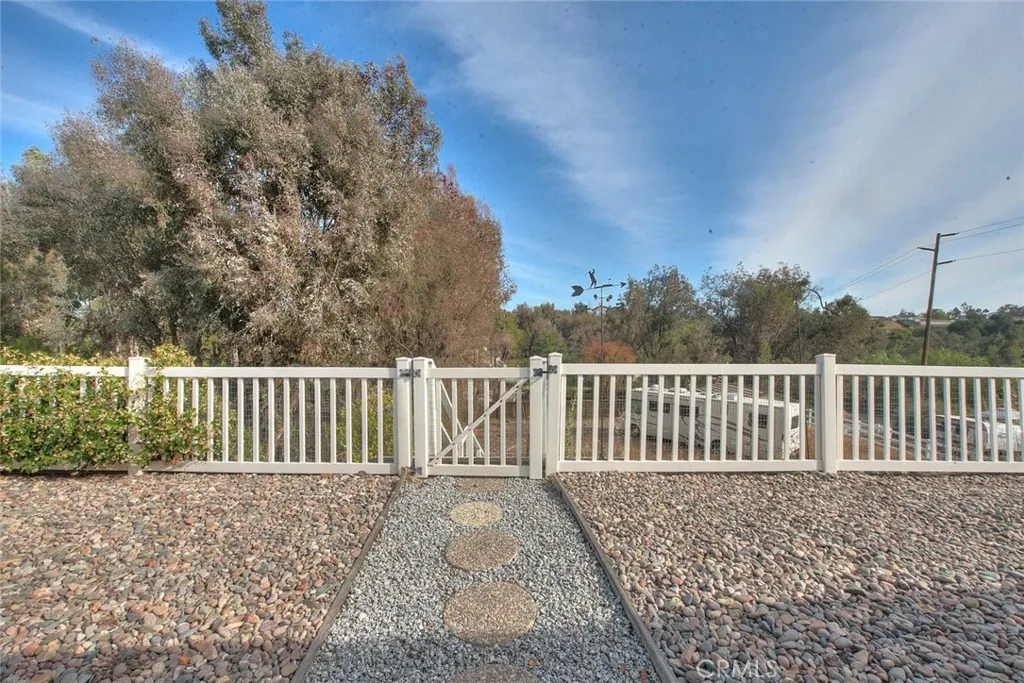 Gateway To Lower Area Which Has Approximately 1/3 Acre Of Two Flat Areas Ideal For Pool And Entertainment Complex