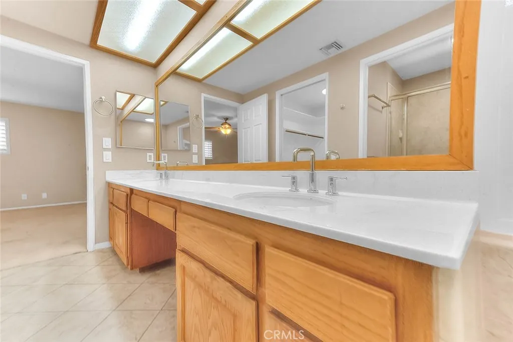 Ensuite Bathroom With Double Sink, Full Length Mirrow And Easy Care Tiled Flooring.  All Bath Fixtures Are New.