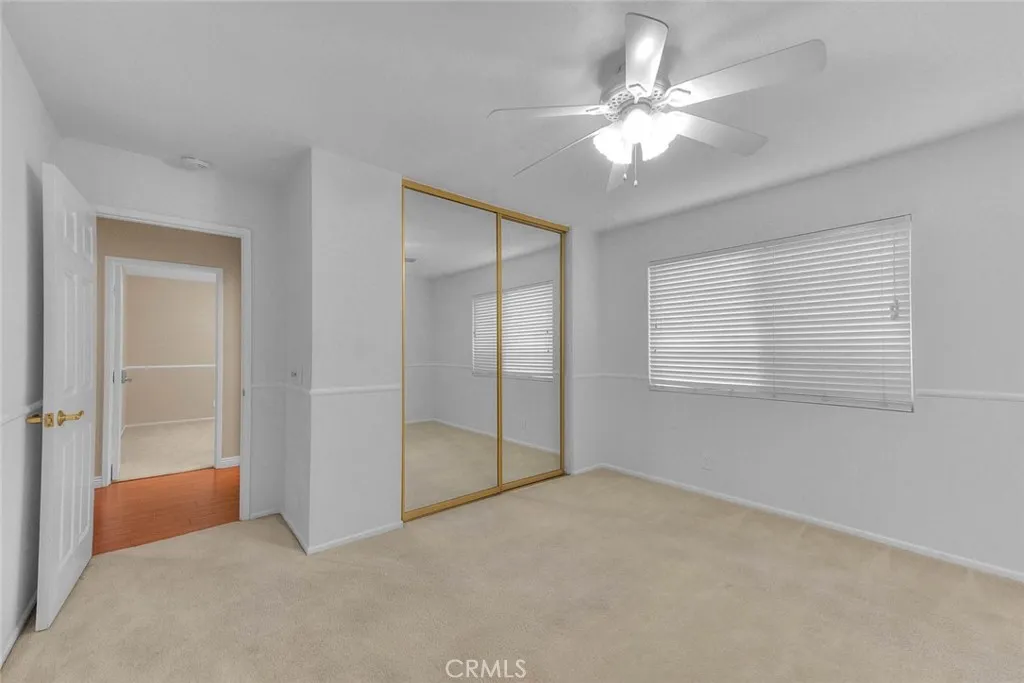 Spacious Bedroom Two With Mirrored Closet Doors.  Closet Has Both Selves And Drawered Cabinets