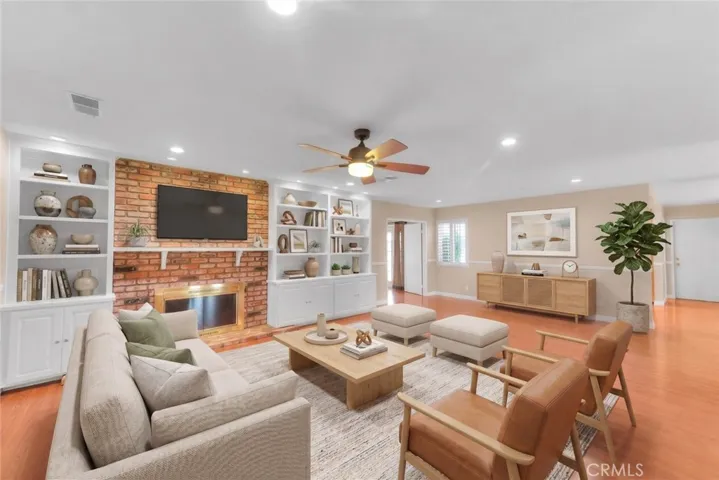 Living Room View From Foyer.  Builtin Display Cases With Bottom Cabinets.  Fireplace For Cozy Evenings.  Ceiling Fan For Cooling Breeze.  (Furniture Is Virtually Staged)