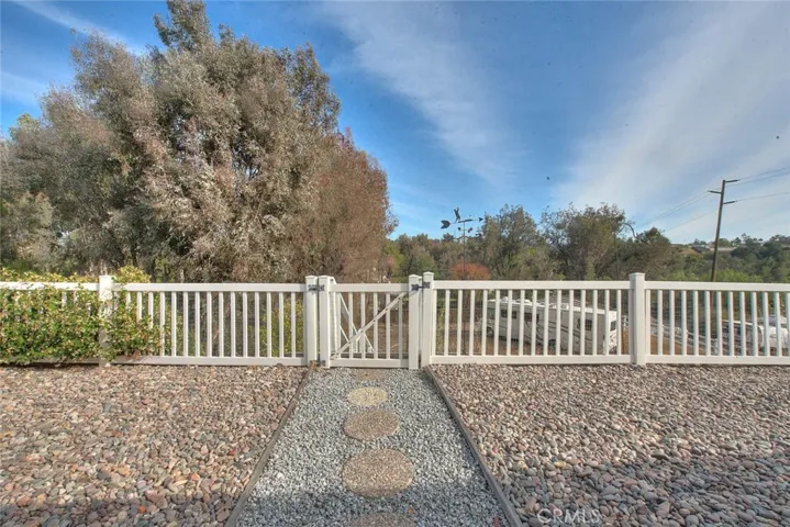 Gateway To Lower Area Which Has Approximately 1/3 Acre Of Two Flat Areas Ideal For Pool And Entertainment Complex