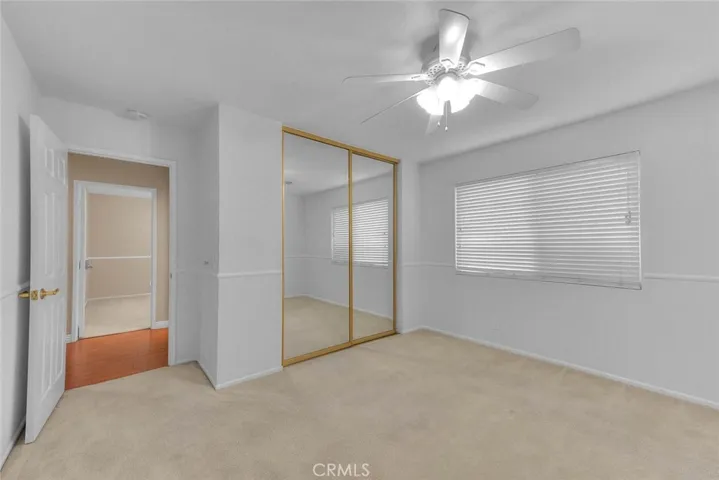 Spacious Bedroom Two With Mirrored Closet Doors.  Closet Has Both Selves And Drawered Cabinets