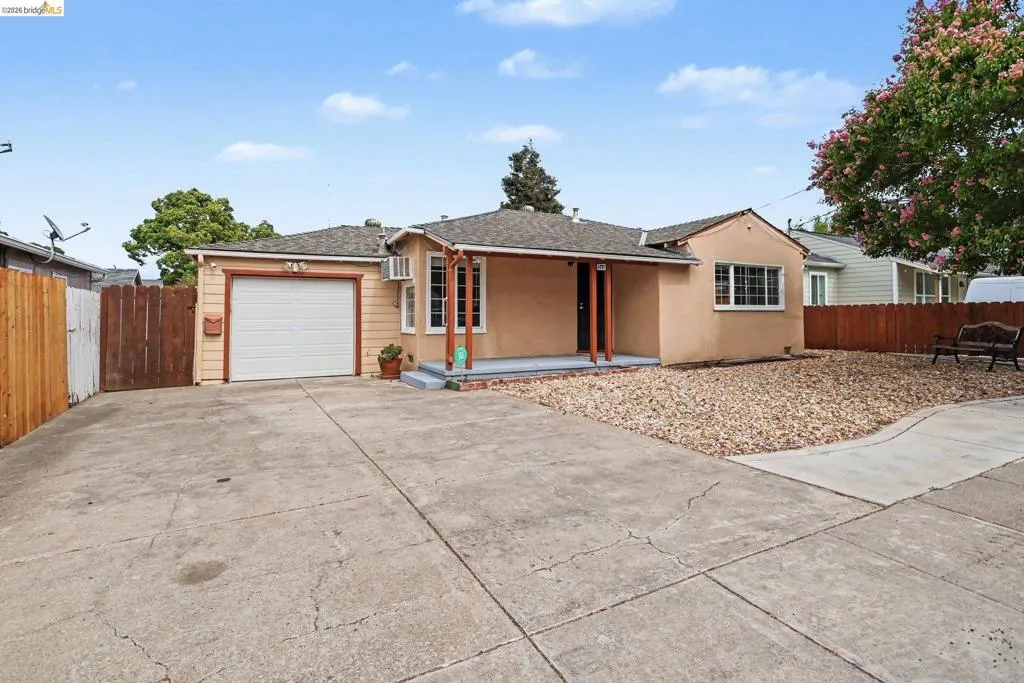 Single-story residence featuring a stucco exterior, attached single-car garage, and a concrete driveway