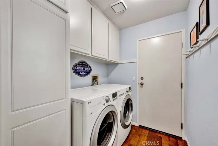 Inside laundry with storage cabinets. Direct garage access.