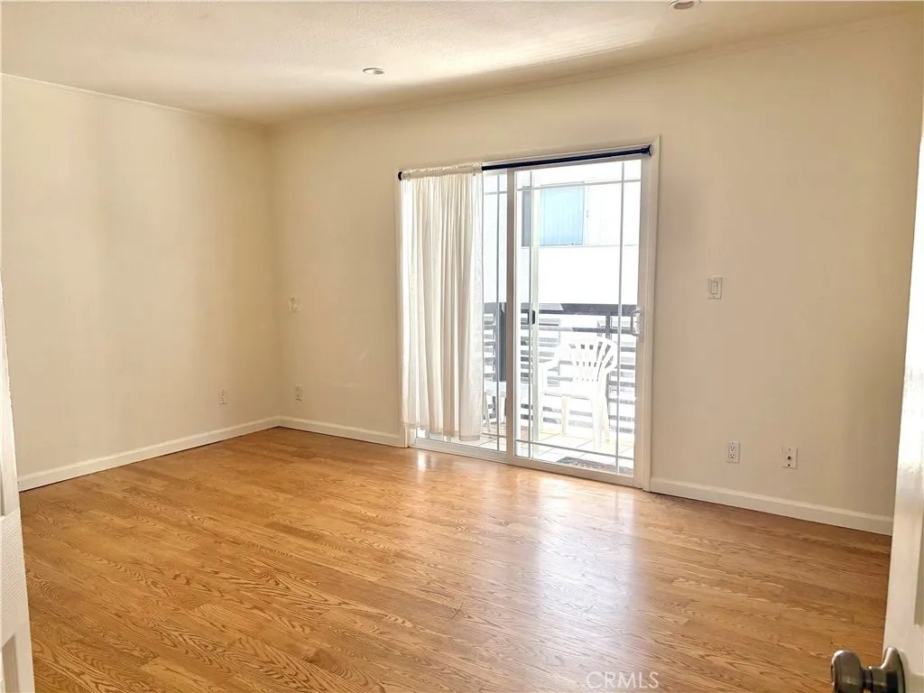 master bedroom with doors to the back cement yard