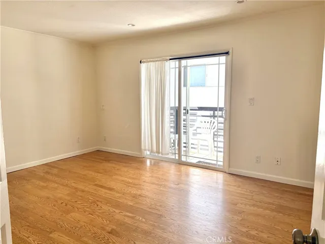 master bedroom with doors to the back cement yard