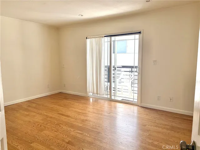 master bedroom with doors to the back cement yard