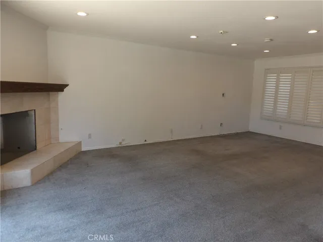 Living Room with fireplace, plantation shutters
