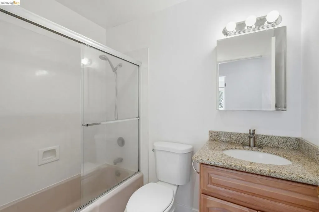 Hall Bathroom features shower over tub.