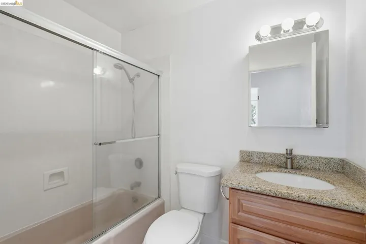 Hall Bathroom features shower over tub.