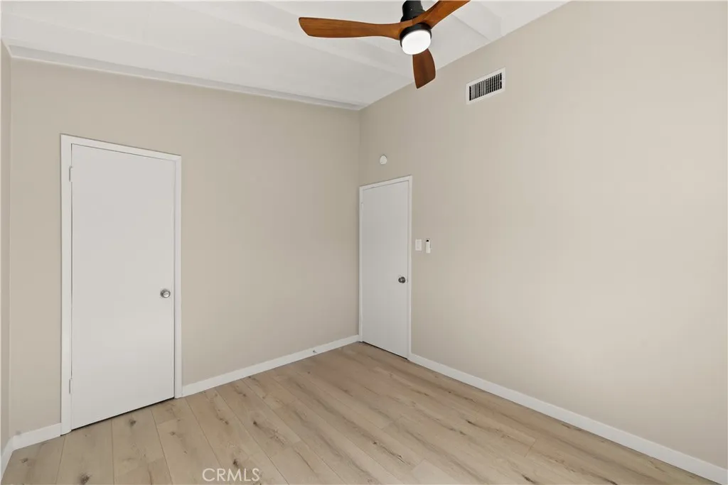 Guest bedroom freshly painted and wit beautiful flooring.