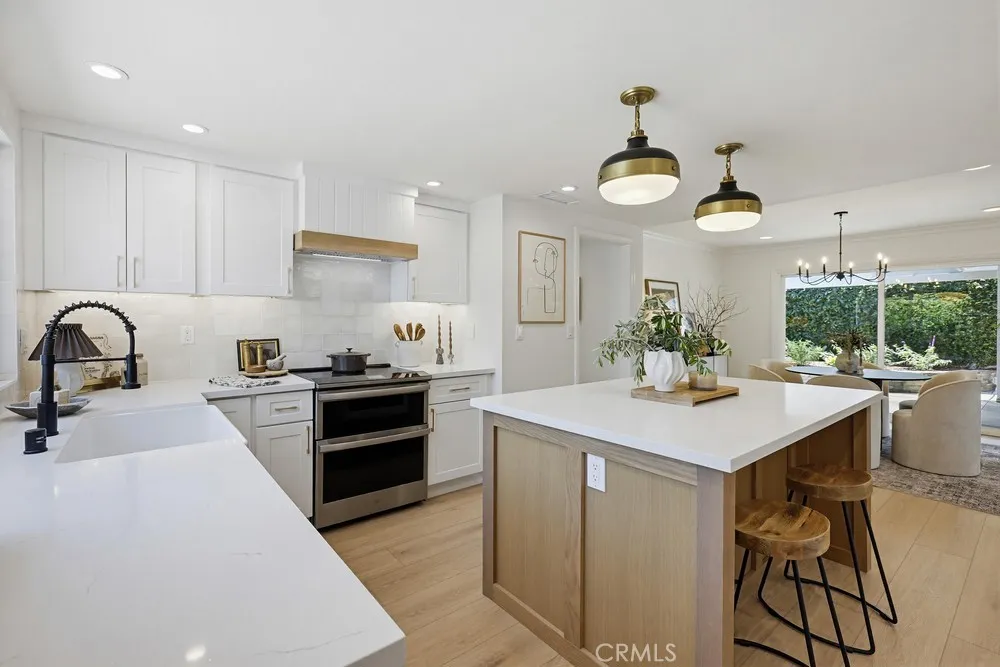 Kitchen w/pendent lights over Oak Island