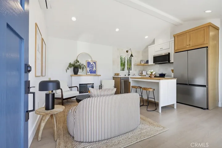 ADU entry showing fireplace and vaulted ceiling