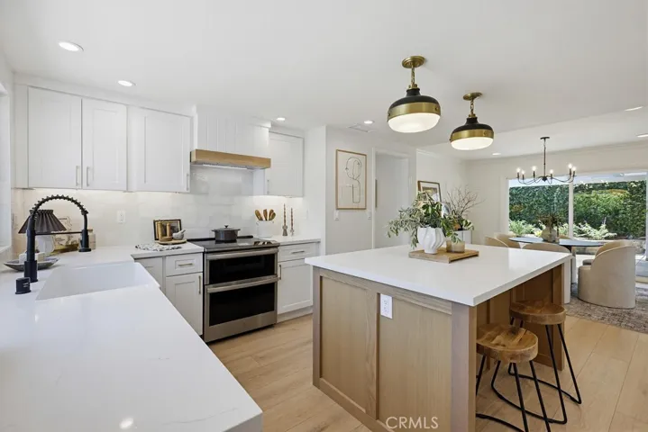 Kitchen w/pendent lights over Oak Island