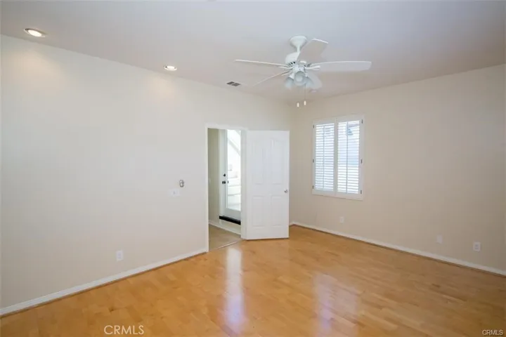 Primary bedroom with en-suite bath and large walk-in closet and fireplace.