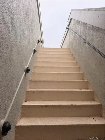 Stairs to large roof-top deck with ocean views.