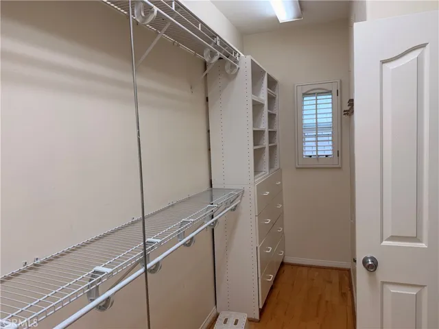 Primary bedroom with en-suite bath and large walk-in closet and fireplace.