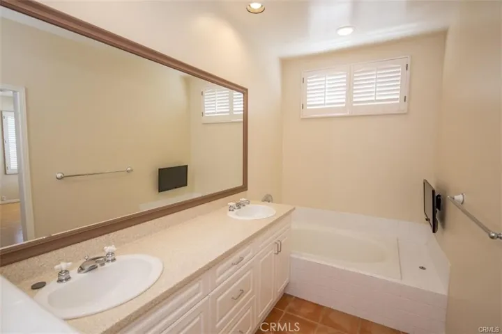 Primary bedroom with en-suite bath and large walk-in closet and fireplace.