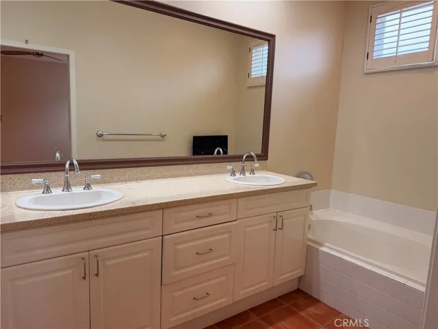 Primary bedroom with en-suite bath and large walk-in closet and fireplace.