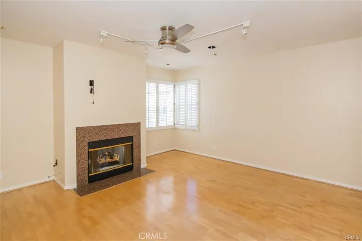 Primary bedroom with en-suite bath and large walk-in closet and fireplace.