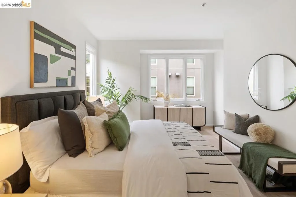 Bright interior space featuring a multi-pane window, light wood-finish flooring, and crisp white walls Bright interior space featuring a multi-pane window, light wood-finish flooring, and crisp white walls