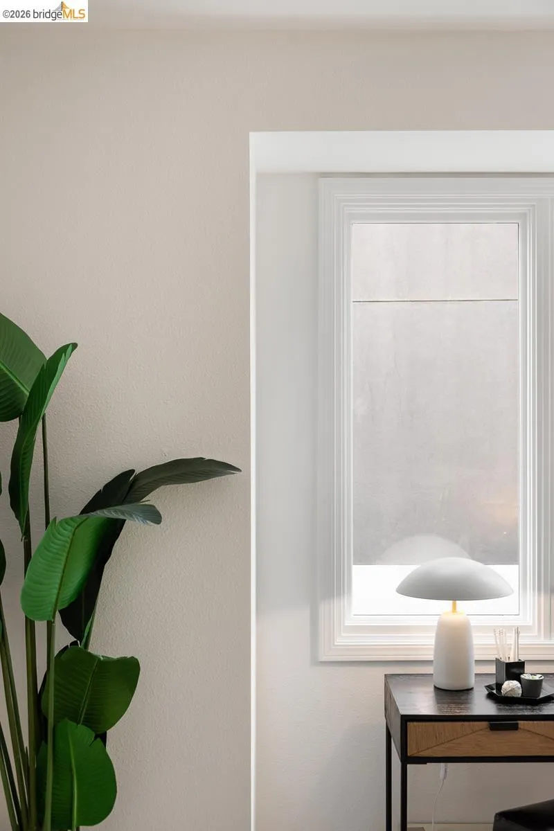 White-framed window with a textured roller shade White-framed window with a textured roller shade