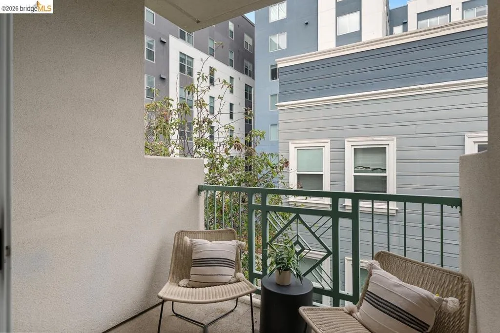 Private balcony featuring a textured stucco wall and decorative metal railing Private balcony featuring a textured stucco wall and decorative metal railing