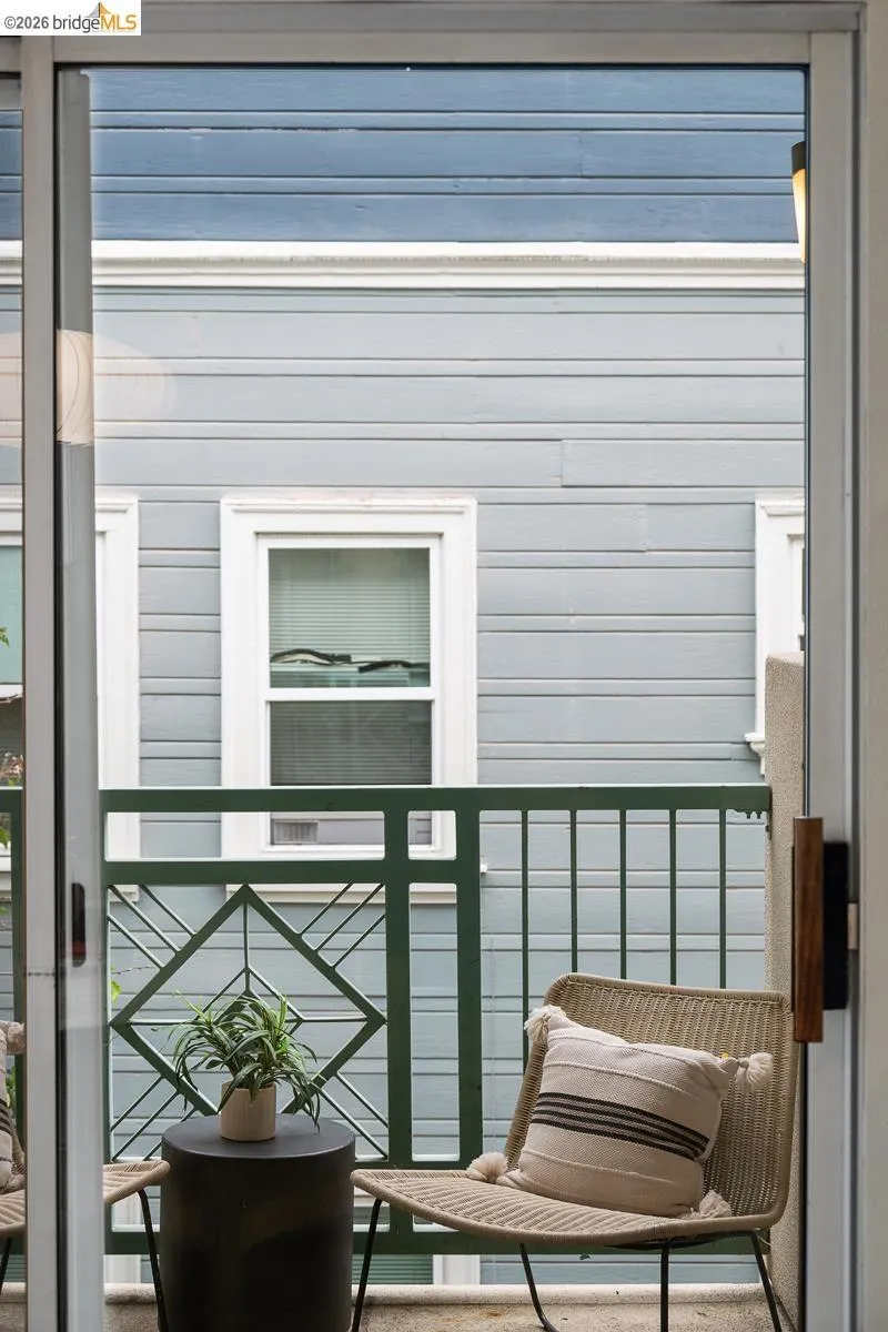 Sliding glass door opening to a private balcony featuring a decorative metal railing Sliding glass door opening to a private balcony featuring a decorative metal railing