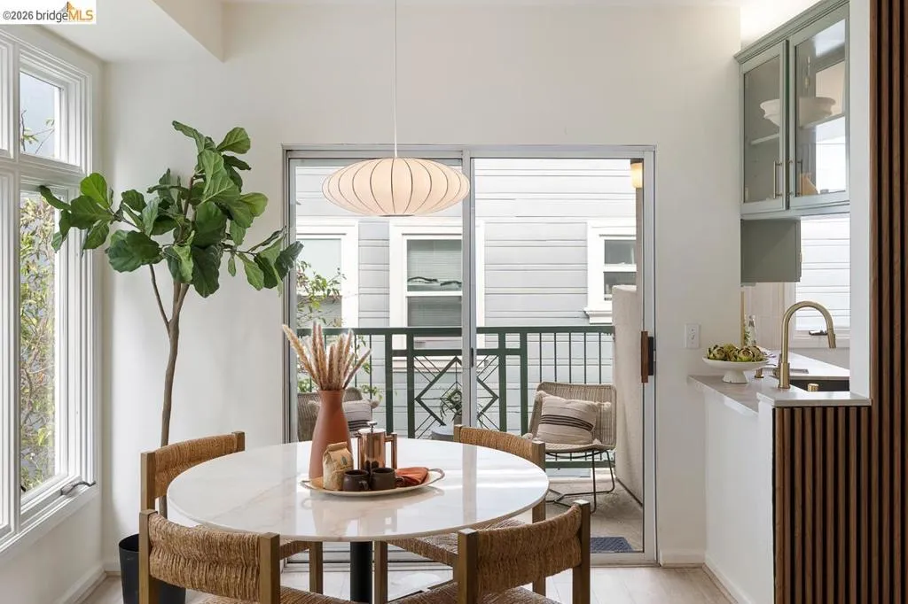 Dining area featuring a round stone-finish table and a contemporary pendant light Dining area featuring a round stone-finish table and a contemporary pendant light