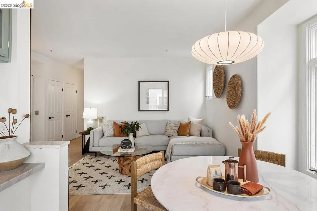 Open-concept living space featuring light wood-finish flooring and white walls Open-concept living space featuring light wood-finish flooring and white walls