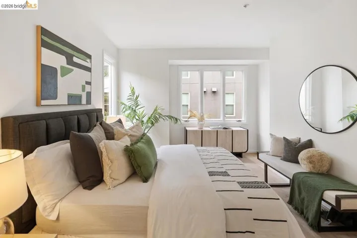 Bright interior space featuring a multi-pane window, light wood-finish flooring, and crisp white walls