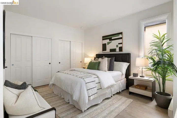 Light wood-finish flooring with a textured area rug
