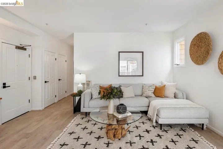 Living area featuring light wood-finish flooring and white walls