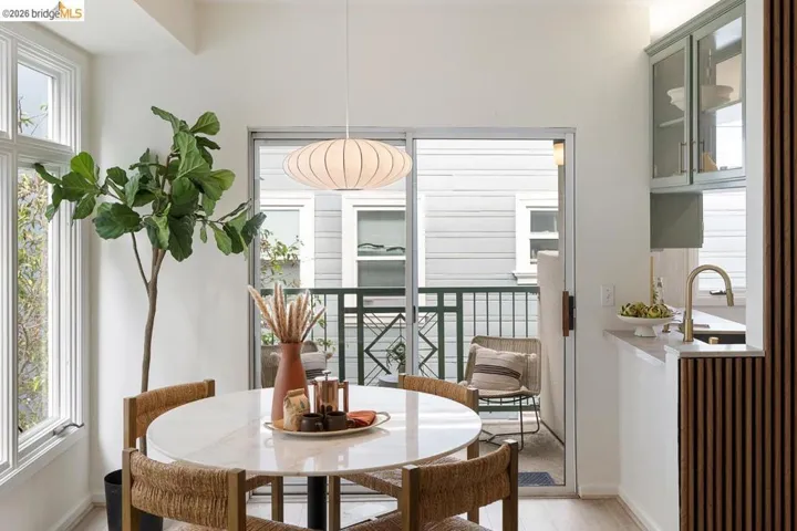 Dining area featuring a round stone-finish table and a contemporary pendant light