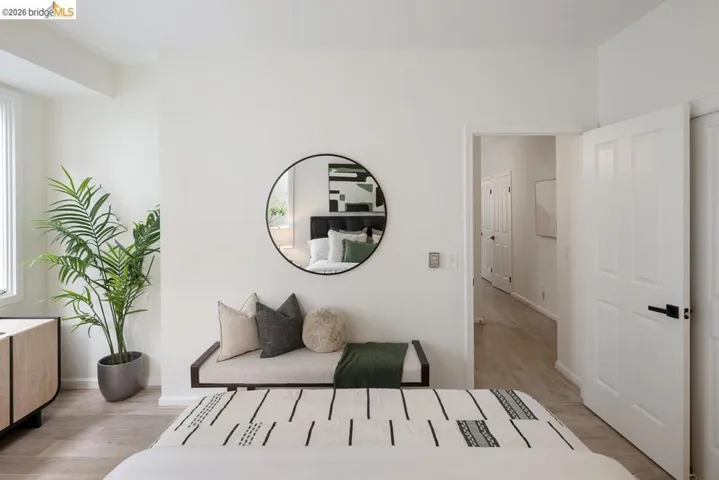 Bright interior space featuring light wood-finish flooring, white walls, and a large window