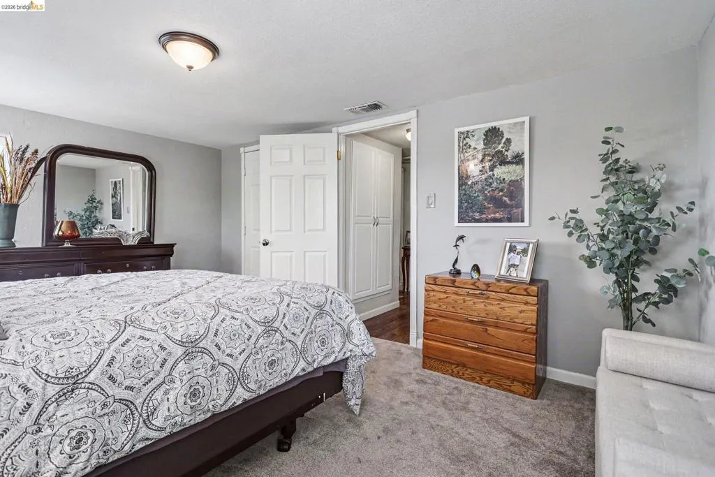 Carpeted room featuring light gray wall paint and a flush-mount ceiling light