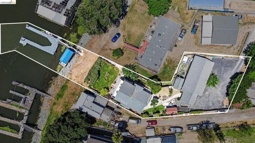 Aerial property overview highlighting a waterfront parcel with an extensive private dock