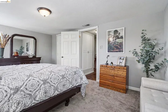 Carpeted room featuring light gray wall paint and a flush-mount ceiling light