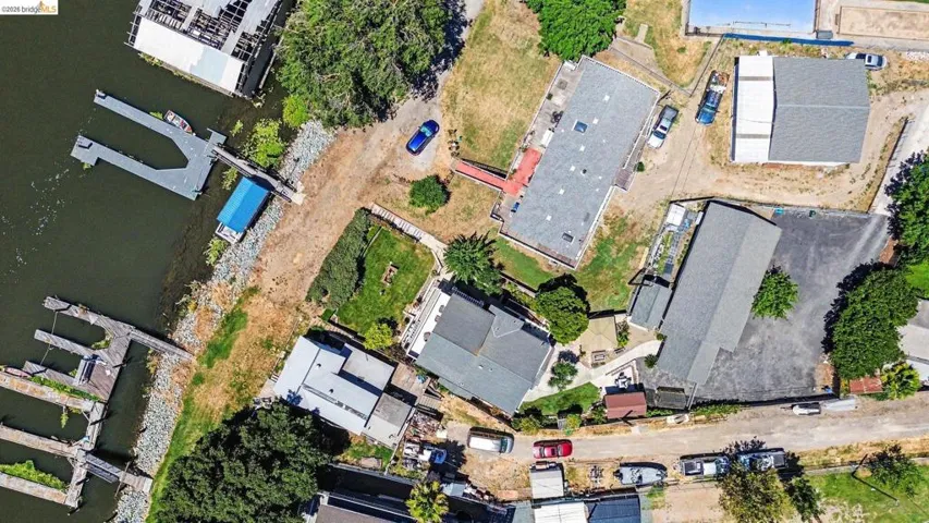 Waterfront property featuring multiple structures, private boat slips, extensive shoreline, and paved access roads