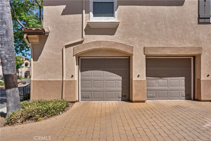 ATTACHED ONE-GARAGE LOCATED WITHIN THE COURTYARD.
