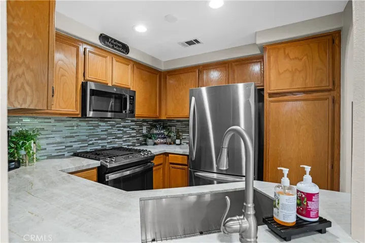KITCHEN FEATURING AN UPGRADED STAINLESS-STEEL RANGE WITH GRIDDLE.
