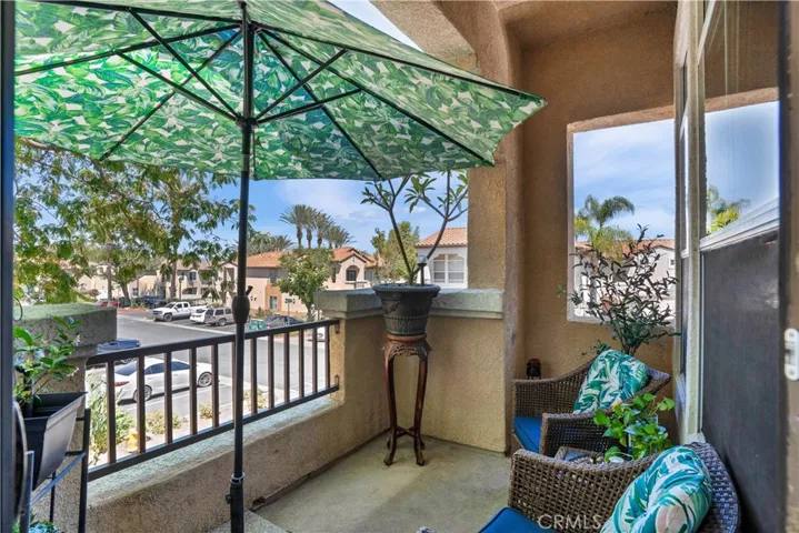 PARTIALLY COVERED PRIVATE BALCONY WITH ROOM FOR OUTDOOR SEATING.