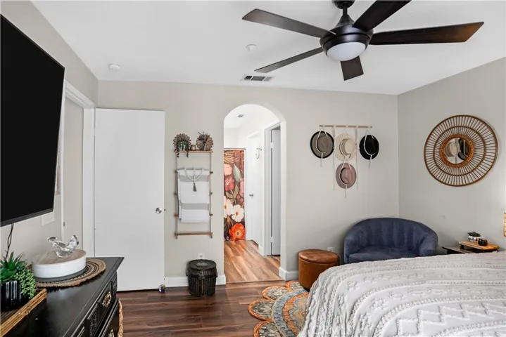 PRIMARY SUITE WITH CEILING FAN, LVP FLOORING, AND ROOM FOR A SITTING AREA.