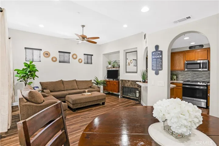 OPEN-CONCEPT DINING AREA AND FAMILY ROOM WITH FIREPLACE.
